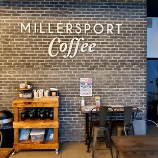 a brick wall with a sign that says millersport coffee