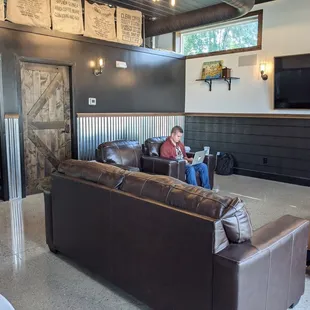 a man sitting on a couch in a coffeehouse
