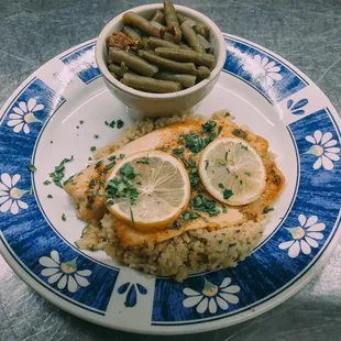 Grilled tilapia over a bed of rice pilaf with green beans