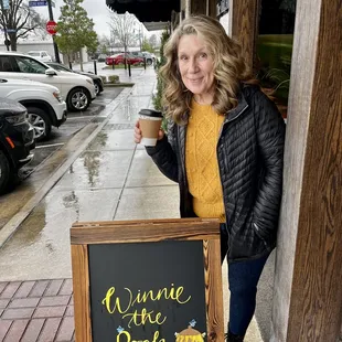 a woman holding a cup of coffee