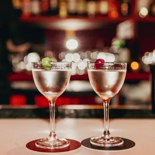 two glasses of wine on a bar