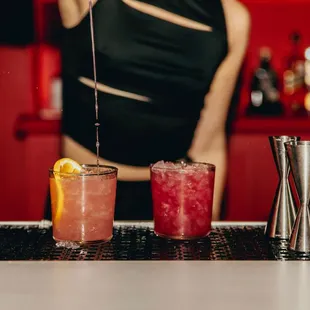 a bartender preparing cocktails at a bar