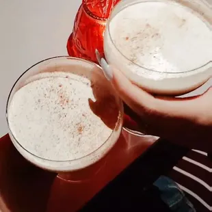 two glasses of beer on a table