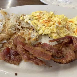 Bacon, sausage links, eggs and fried potatoes