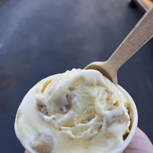 a hand holding a cup of ice cream