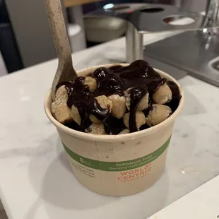 Brownie batter ice cream topped with cookie dough bits and hot fudge