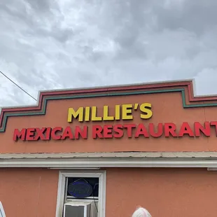 a woman and a woman standing in front of the restaurant