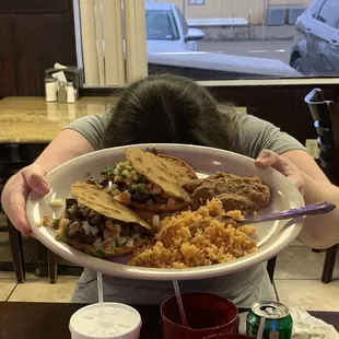 a woman holding a plate of food