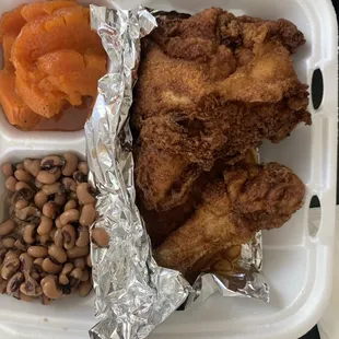 chicken, beans, and carrots in a styrofoam container