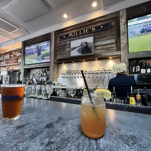 two glasses of beer on a bar