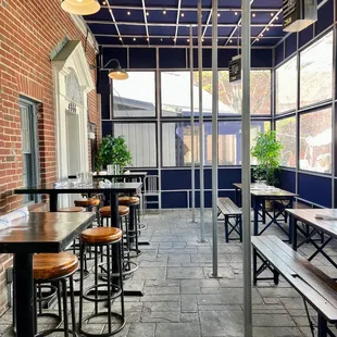 a row of tables and stools on a patio