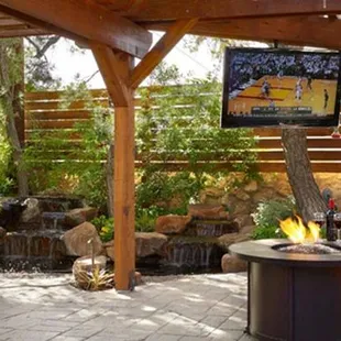 a patio with a fire pit