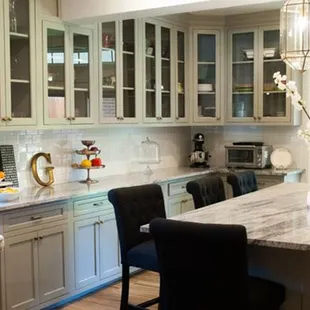 a kitchen with marble counter tops and a center island