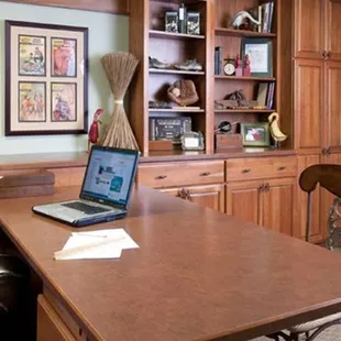 a home office with a laptop on a desk