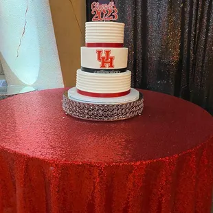 a wedding cake on a red tablecloth