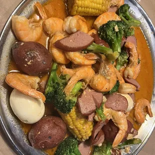 Headless shrimp with egg, broccoli, sausage, corn and potatoes