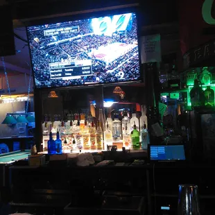 a bar with a large screen tv