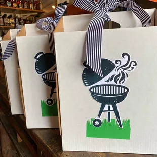 a row of gift bags with bbq designs