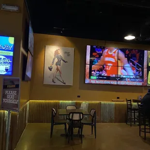 a man sitting at a table watching tvs