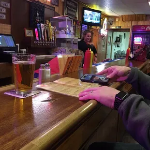 a person using a cell phone at a bar