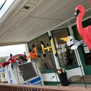 a pink flamingo on the front porch