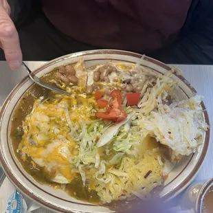 Huevos Rancheros eggs over medium smothered in green