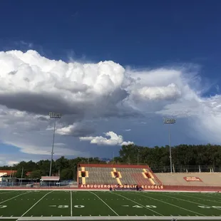 The smaller visitor section is across the field.