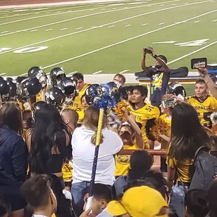 Highland Hornets gathered around the players after a big win!