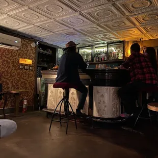 two people sitting at a bar