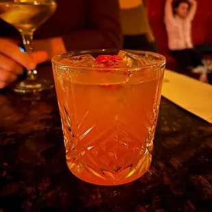a person sitting at a table with a drink
