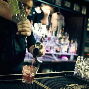 a bartender pouring a drink