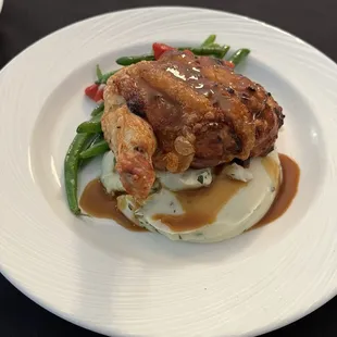 Tuscan stuffed chicken with parmesan herb mashed potatoes and sautéed green beans and peppers