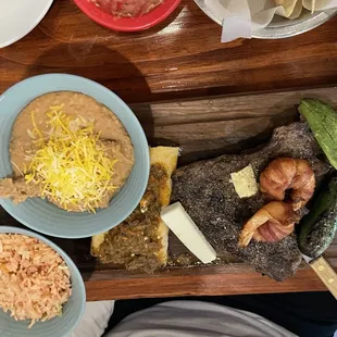 Carne asada, enchiladas, and bacon wrapped shrimp.