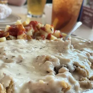 Chicken fried steak country potatoes eggs and a tea