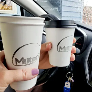 two cups of coffee in a car
