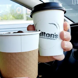a person holding a cup of coffee