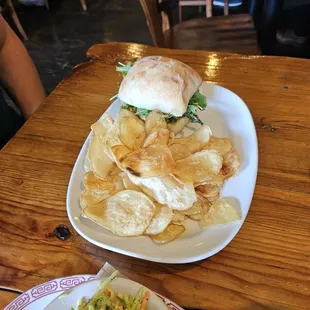Egg and asparagus sandwich, chips and broccoli slaw