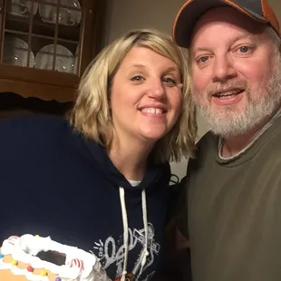 a man and woman with a gingerbread cake