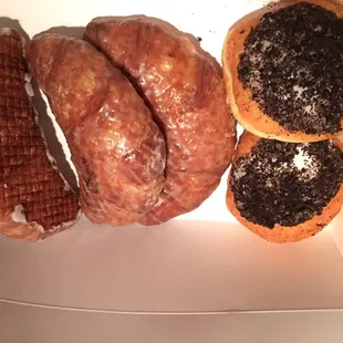 Glazed crescent donuts and ores topped cream filled