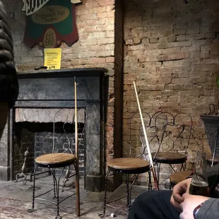 a man sitting in front of a fireplace
