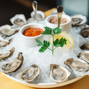 a platter of oysters on ice