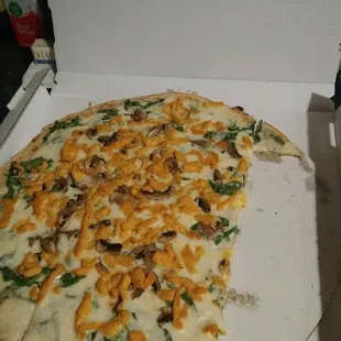 a half eaten pizza in a box