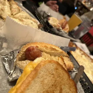 a hot dog with cheese and mustard