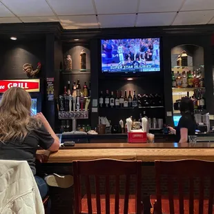 two people sitting at the bar
