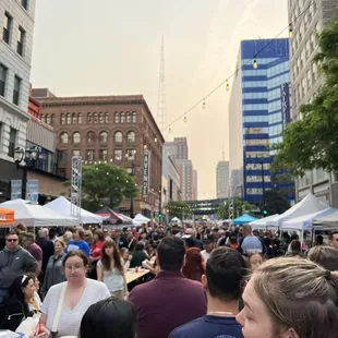 a crowd of people walking down the street