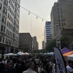 a crowd of people walking down the street