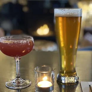 two glasses of beer and a candle