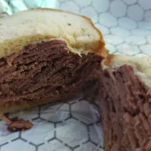 Sad looking pastrami sandwich on generic white bread wonder like