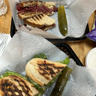 two sandwiches with pickles