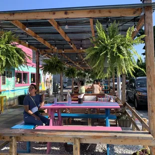 a woman sitting at a colorful table